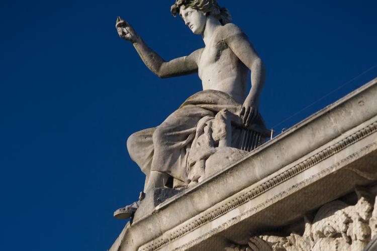 Apollo statue on top of building